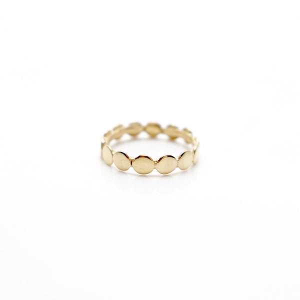Second close up of handcrafted designed jewelry 14 carat gold dot ring on a white background