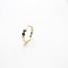 14 carat handmade, Granville Island artisan crafted gold dot ring standing on end on white background.