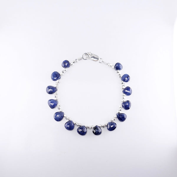 Overhead view of beautiful blue sapphire and silver beaded bracelet.
