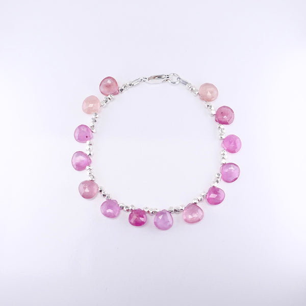 Over head picture of beautiful pink sapphire silver beaded bracelet.