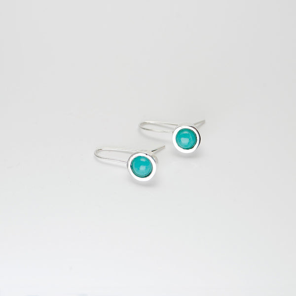 Side view of handmade artisan jewelry of hanging silver earrings with amazonite.