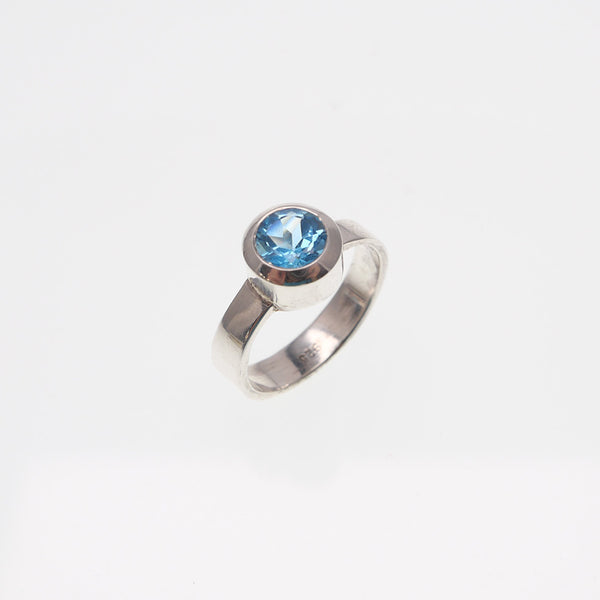 Angled view of blue topaz sterling silver ring made by Granville Island Silversmith.