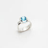 Handmade silver ring with blue topaz gem in  two prong setting.