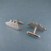 Close up of sterling silver cruise ship cufflinks with one showing the backing clasp.