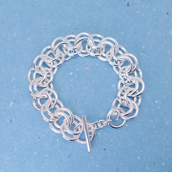 Handcrafted silver bracelet with double rings, showing the bar clasp. 