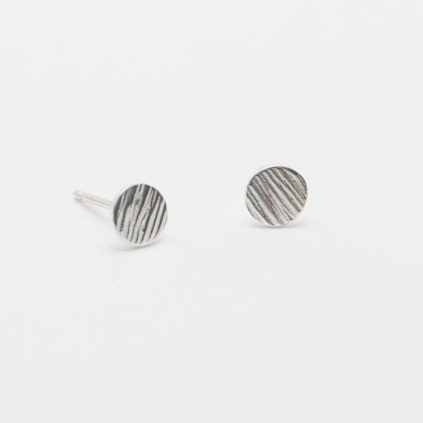Silver circle stud earrings, with handmade hammered lines. 