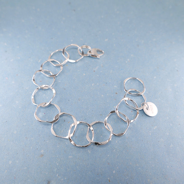 Sterling silver handmade jewelry link bracelet in full view. 