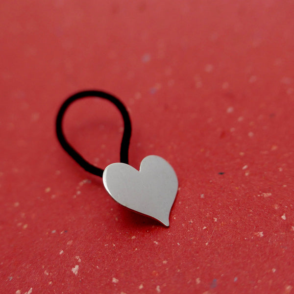 Angled view of silver heart hair tie by Granville Island Jeweler.