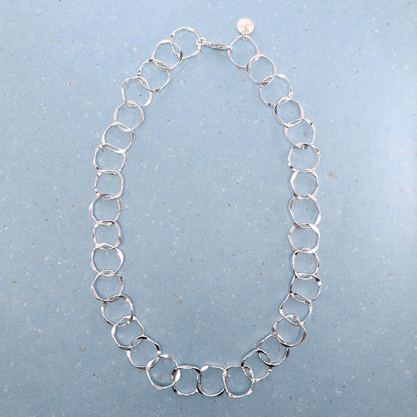Top view showing entire handmade jewelry link Sterling silver chain necklace.