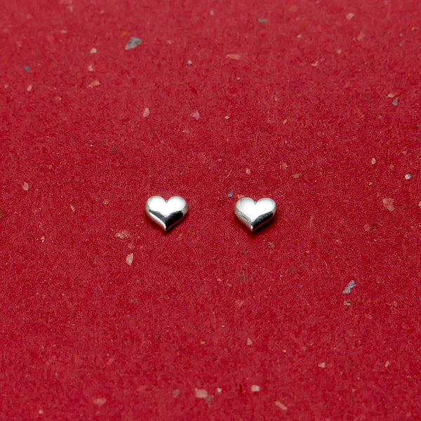 Side by side view of Granville Island artisan jewelry heart stud earrings.
