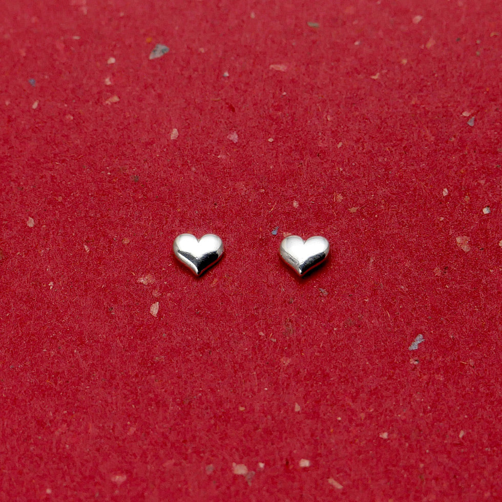 Side by side view of Granville Island artisan jewelry heart stud earrings.
