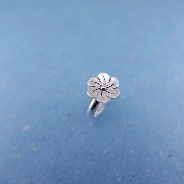Close up of silver sakura flower ring.